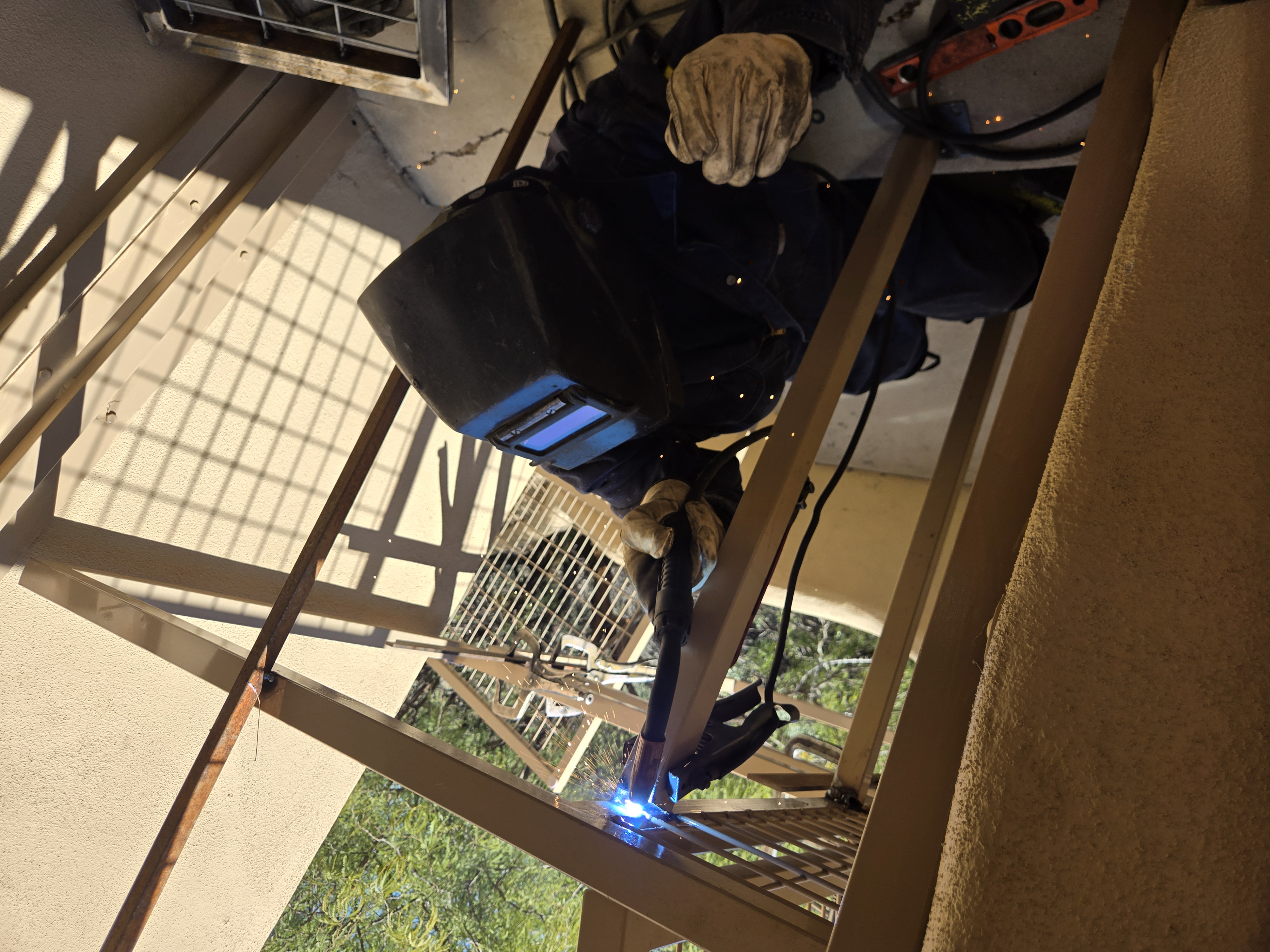 Close-up of welder creating a perfect joint with MIG torch and bright blue arc